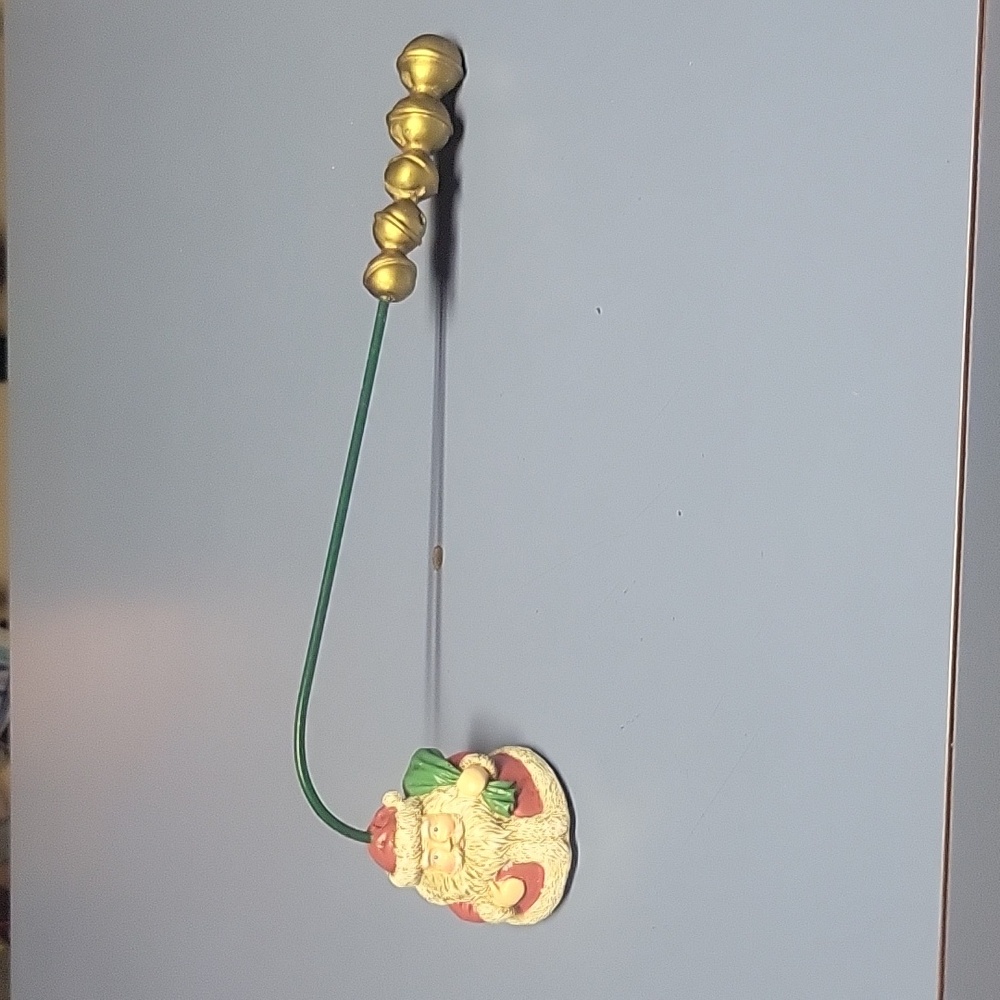 Vintage Santa  candle snuffer. Red green and gold in color